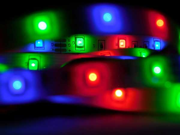 zishan-khan-NHnW3cmrCeo-unsplash Close-up of vibrant RGB LED strip lights glowing in red, green, and blue, highlighting the intricate circuitry and vivid illumination.