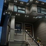 Modern home exterior at night with bright LED lights accentuating the roofline and entryway, creating a clean and contemporary look under the evening sky.