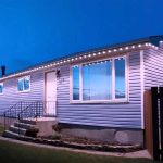 Single-story house illuminated by bright LED lights along the roofline, creating a clean and modern appearance during twilight.