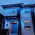 Modern two-storey home featuring professionally installed blue and white permanent LED roofline lighting.